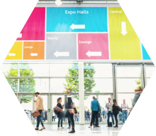 photo - multiple people in a lobby with colourful sign overhead