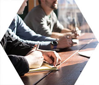 photo - closeup of several people in a meeting