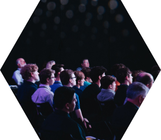photo - an audience sits in an auditorium
