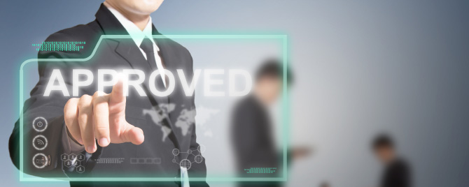 Photo – a man in a suit presses a folder marked ‘approved'