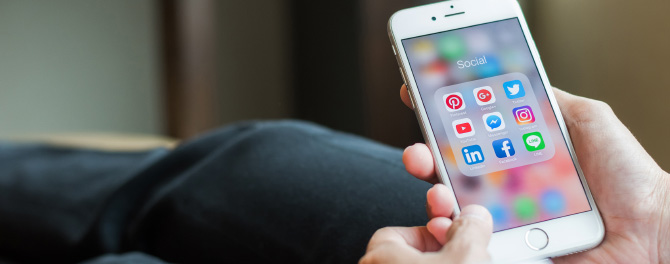 photo – closeup of a phone with social media icons