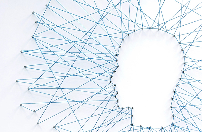 photo - a silhouette of a human face in profile formed with pins and string