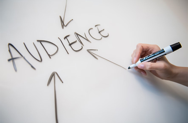 photo - close up of a hand writing the word "Audience" on a whiteboard
