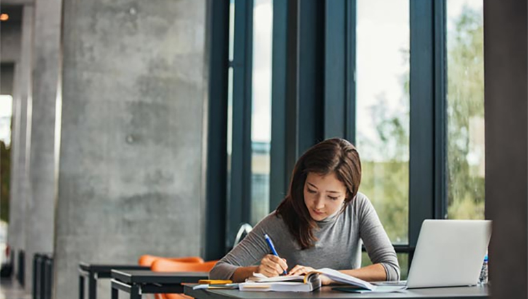 photo - a woman working on paperwork at a desk