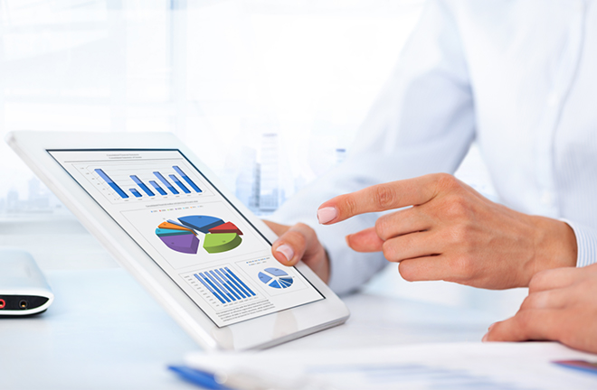 photo - someone using a tablet device with data visualisations displayed on its screen